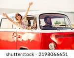 Portrait of group overjoyed cool fellows drive vintage van raise hands through window enjoy sunny weather
