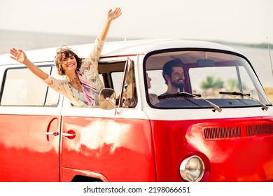 Portrait of group overjoyed cool fellows drive vintage van raise hands through window enjoy sunny weather - Powered by Shutterstock