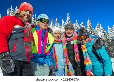 Portrait Of Group Of Skiers Standing On Ski Slope