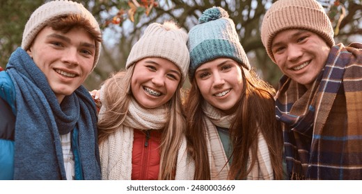 Portrait Of Group Of Smiling Teenage Girls And Boys Outdoors Dressed For Winter Or Autumn - Powered by Shutterstock