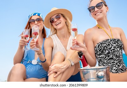 Portrait Group Of Three Young Adult Beautiful Caucasian Girlfriends Enjoy Drinking Champagne Cocktail Celeberate Bachelorette Party Event Pool Seaside Beach On Summer Day. Friends Cheers Clink Wine