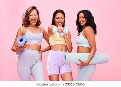 Portrait, group and women with fitness, smile and pilates training on a pink studio background. Funny, girls and friends with exercise, self care and health with wellness, meditation and yoga mat - Powered by Shutterstock