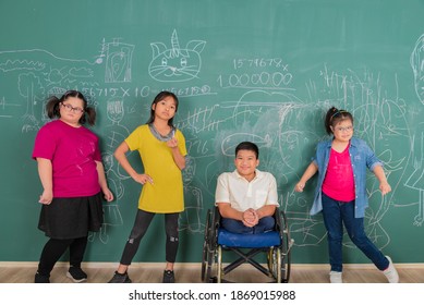 Portrait group of young Asian disabled child student standing in front of chalkboard in element classroom