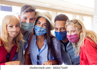 Portrait Group Of Young Happy Friends Wearing Face Mask During Covid Pandemic Smiling At The Camera. Multiracial People Taking A Selfie Outdoor Having Fun Together. New Normal Lifestyle Concept.