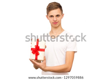 portrait of a guy with a gift, isolate, the guy in a white T-shirt gives a gift