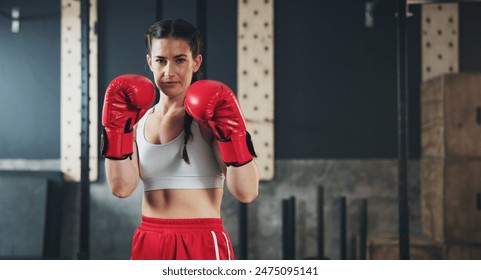 Portrait, gym and boxing glove with workout, woman and practice for match and sports with endurance. Challenge, fighter or boxer with training or girl in fitness centre or progress with health - Powered by Shutterstock