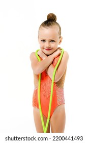 Portrait Of Gymnast Little Girl With Jumping Rope In Bright Festive Leotard And Makeup, Doll Face Of Sportive Smiling Child