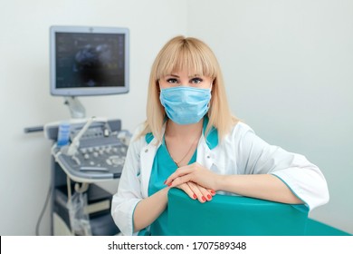 Portrait Of Gynecologist With Ultrasound Machine In A Protective Mask