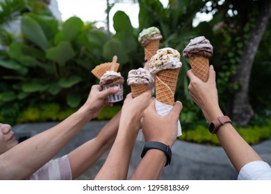 Portrait Of Hands Holding Ice Cream Cone Make A Toast When A Party Background Green Trees