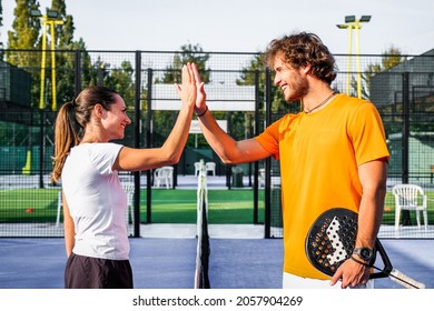 Portrait of handshake of two padel tennis players - Padel players embracing after win a padel match - Powered by Shutterstock