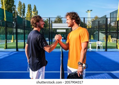 Portrait of handshake of two padel tennis players - Padel players embracing after win a padel match - Powered by Shutterstock