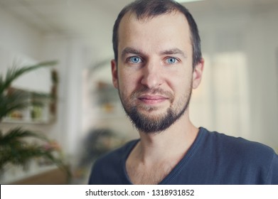 Portrait Of Handsome 35 Year Old Man At Home. Blured Background.