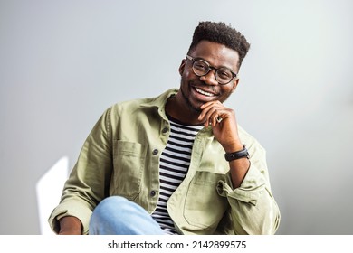 A portrait of a handsome African American man. Serious dark skinned businessman has strict look, contemplates about new business project, dressed in casual t shirt, spends free time at office.