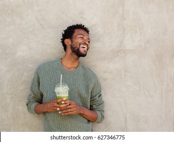 Portrait of handsome african american man with healthy smoothie - Powered by Shutterstock