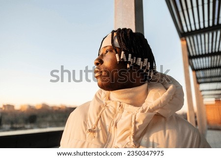 Similar – Black young man listening to music in a sunny day