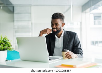 Portrait Of Handsome African Black Young Business Man Working On Laptop Computer At Office Desk