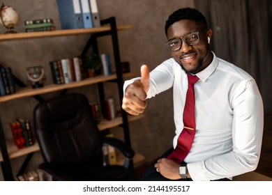 Portrait Of Handsome African Business Man With Red Tie And Black Glasses In The Office. High Quality Photo