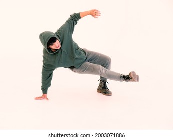 Portrait Of Handsome Asian Hip Hop Dancer Dancing In The Studio, Isolated On White Background.