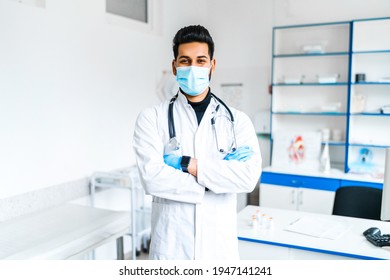 Portrait of a handsome Asian male doctor in medical clothes and with a stethoscope. he is in a protective mask, modern medicine, hospital, internship. modern hospital.
