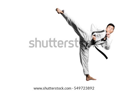 Portrait of a handsome asian man kick with taekwondo black belt . Isolated on white background with copy space