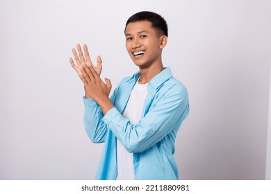 Portrait Of Handsome Asian Man Wearing Casual Outfit Isolated On White Background Happy Clapping Succesful