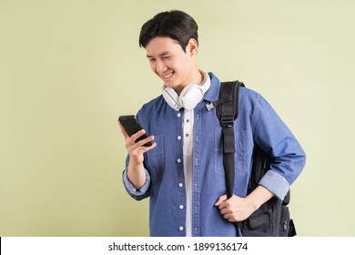 Portrait Of Handsome Asian Student Using Smart Phone
