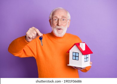 Portrait Of Handsome Astonished Person Arm Hold Key Small House Cant Believe Isolated On Purple Color Background