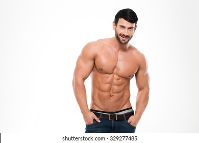 Portrait of a handsome athletic man with naked torso standing isolated on a white background