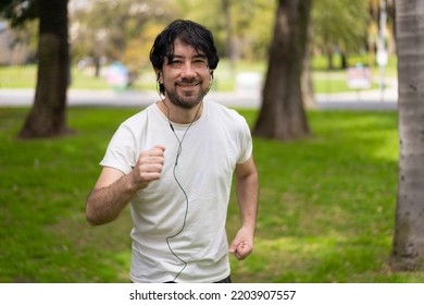 Portrait Of Handsome Attractive Mature Bearded Athletic Latin Man Guy 40s In Casual White T-shirt Running At A Park