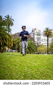 Portrait Of Handsome Attractive Mature Bearded Athletic Latin Man Guy 40s In Casual Blue T-shirt Running At A Park