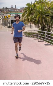 Portrait Of Handsome Attractive Mature Bearded Athletic Latin Man Guy 40s In Casual Blue T-shirt Running At A Park.