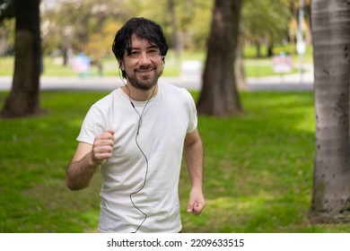 Portrait Of Handsome Attractive Mature Bearded Athletic Latin Man Guy 40s In Casual White T-shirt Running At A Park