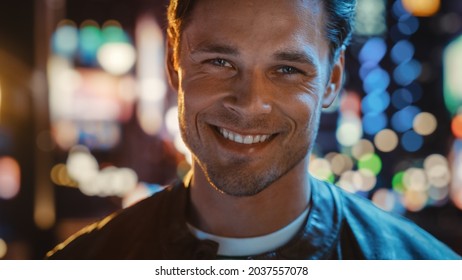 Portrait of Handsome Blonde Man Smiling, Looking at Camera, Standing in Night City with Bokeh Neon Street Lights in Background. Happy Confident Young Man with Stylish Hair. Closeup Tilting Shot - Powered by Shutterstock