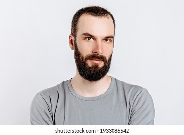 Portrait Of A Handsome Brutal Brunette Serious Man On A White Background. The Person Will Soon Become The Owner Of A Startup Business.