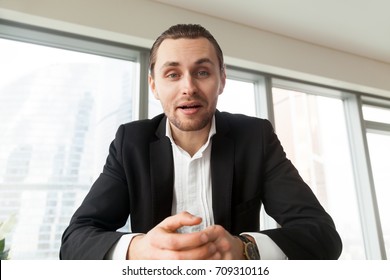 Portrait Of Handsome Businessman Looking In Camera And Talking. Young Successful Entrepreneur Explaining His Point To Business Partners. Business Negotiations, Boss Conducting Job Interview Concept.