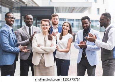 Portrait of an handsome businesswoman in front of his team. recognition, movement on the career ladder, success in business - Shutterstock ID 1151975714