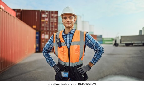 Portrait of a Handsome Caucasian Industrial Engineer in White Hard Hat, Orange High-Visibility Vest, Checkered Shirt, Jeans and Work Gloves. Foreman or Supervisor Has a Two-Way Radio Attached. - Shutterstock ID 1945399843