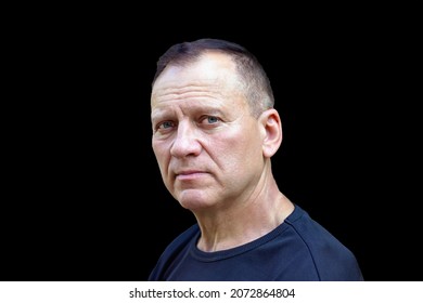 Portrait Of A Handsome Charming Courageous Middle-aged Man, 50-55 Years Old, With A Serious Face, On An Isolated Black Background