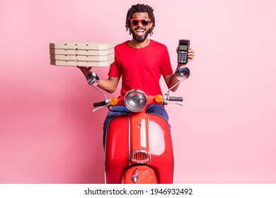 Portrait of handsome cheery guy riding moped delivering pizza holding in hand terminal wireless pay isolated over pink color background - Powered by Shutterstock