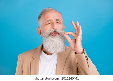 Portrait Of Handsome Classy Dreamy Grey-haired Man Tasting Good Food Cigarette Isolated Over Bright Blue Color Background