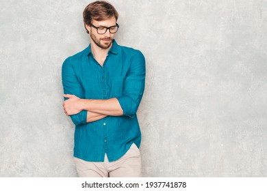 Portrait Of Handsome Confident Hipster Lumbersexual Businessman Model Wearing Casual Jeans Shirt Clothes. Fashion Stylish Man In Eyewear Posing Against Gray Wall In Studio