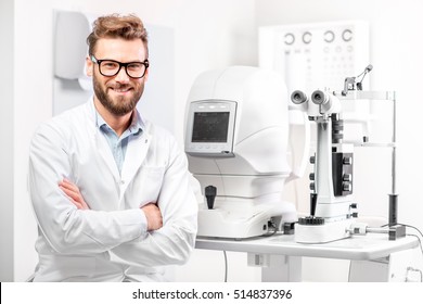 Portrait Of Handsome Eye Doctor Sitting With Ophthalmologic Device In The Cabinet