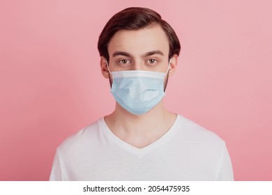 Portrait of handsome focused guy wear protective respiratory on pink background - Shutterstock ID 2054475935