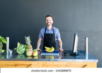 Portrait Of Handsome Grocery Owner Standing At Checkout Counter And Smiling In Store