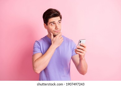 Portrait of handsome guy hand on chin look interested empty space thinking isolated on pink color background - Powered by Shutterstock