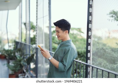 Portrait Of Handsome Guy Using His Cell Phone