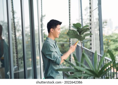 Portrait of handsome guy using his cell phone