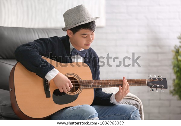portrait-handsome-hipster-guitar-indoors-600w-1036963039.jpg