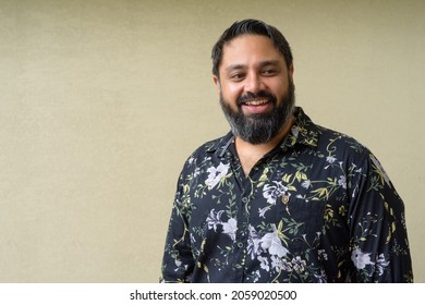 Portrait Of Handsome Indian Man Against Plain Background