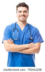 Portrait Of A Handsome Latin Male Nurse Wearing Scrubs And With Arms Crossed In A Studio